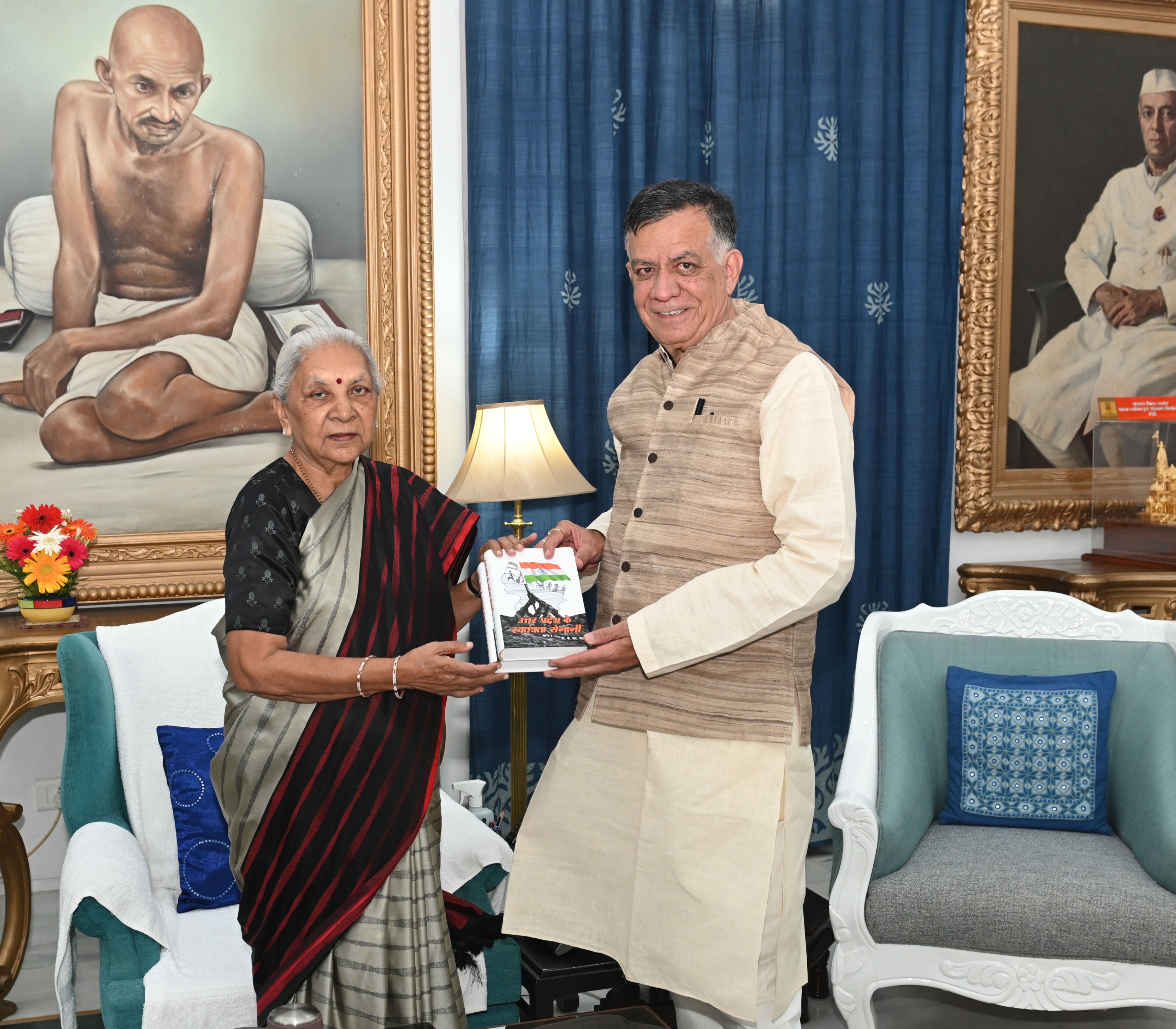 Honble Vidhan Sabha Speaker met the Governor at Raj Bhavan and presented her a book named Freedom Fighters of Uttar Pradesh Part-1